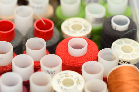 Soft-focus macro background of sewing threads in gentle tones for design, hobby and textile...