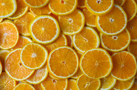 Macro view of juicy orange pulp forming a vivid citrus texture background ideal for packaging and food advertising.の写真素材