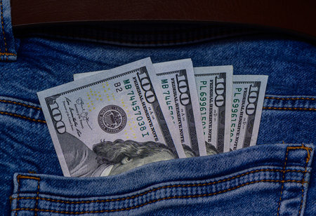 100 dollar notes in denim jeans pocket. Cash and personal finance concept for stock and financial photography.の写真素材
