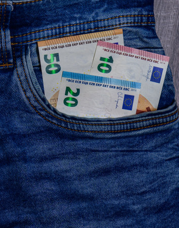 Euro currency notes of different denominations in jeans pocket. Cash and finance concept for personal savings and stock photography.の写真素材