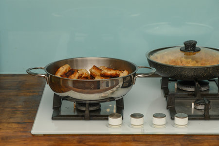 Juicy homemade cutlets frying in a pan on the stove. Delicious golden-brown meat patties, perfect for culinary and food photography.の写真素材