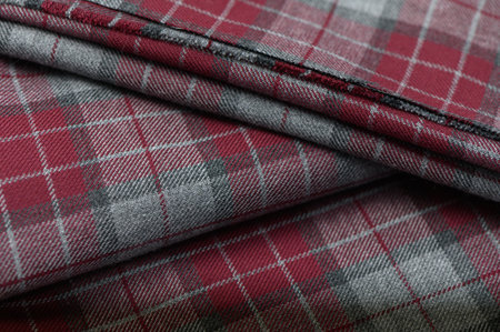 Close-up of fabric with bright red plaid and contrasting lines in traditional Scottish style.の写真素材
