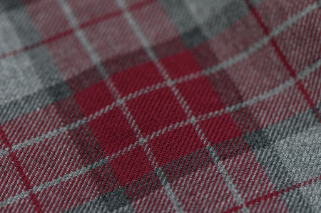 Bright tartan fabric traditionally associated with Scotland, close-up view. The texture and colors highlight classic style and Scottish tradition.の写真素材