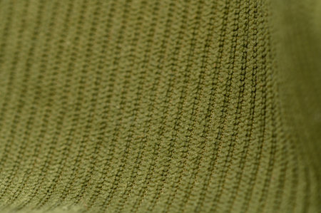 Close-up of dense green fabric with visible fibers and matte surface. Dark green shade and dense relief form a versatile background for textile and graphic projects.の写真素材