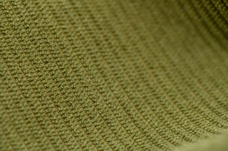 Macro of dense green fabric with deep thread weave and pronounced relief. Grassy green shade and sturdy texture create a versatile background for bags, clothing, and interior designの写真素材