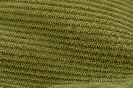 Close-up of green fabric with dense weave and matte surface. Dark green tone and subtle relief form a calm background for interior textiles and graphic compositions.の写真素材