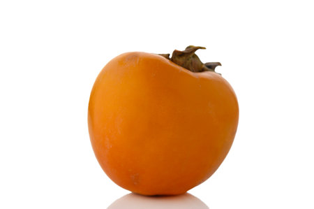 Juicy and appetizing ripe persimmon on a white background. Bright orange fruit symbolizing autumn and health. Perfect for design, food blogs, advertising, and healthy lifestyle concepts.の写真素材