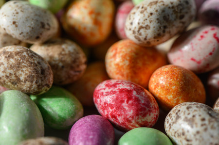Studio shot of peanuts in milk chocolate with matte and glossy multicolored glaze on white...