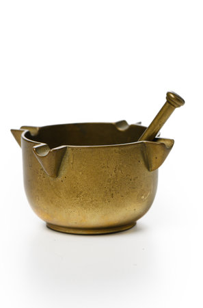 Studio shot of brass mortar and pestle. Clean white background and elegant shape for classic kitchen tool and home cooking.の写真素材