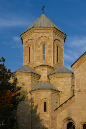 View of Georgian Orthodox church against clear sky. Stone domes, crosses and intricate ornaments...