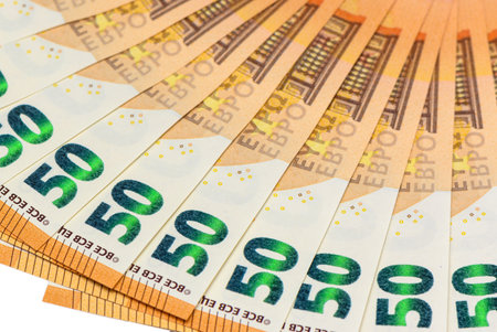 Beautifully fanned arrangement of 50 euro banknotes creating an elegant circular pattern on pure...