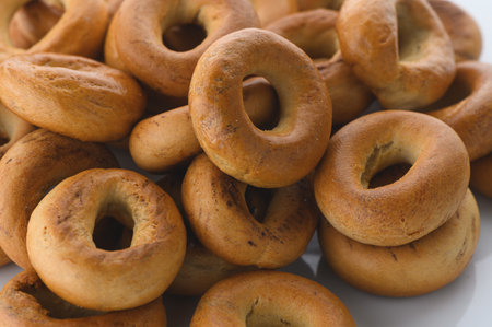 Detailed close-up shot of a pile of traditional East Slavic ring-shaped bread pastries called sushki. Showing the unique texture and golden-brown color of these classic tea-time treats.の写真素材
