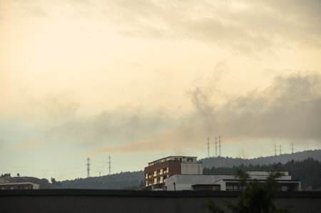 A scenic view of the distant Georgian mountains as seen from the Saburtalo district in Tbilisi. Combines urban residential life with the natural backdrop of the Caucasus foothills.の写真素材