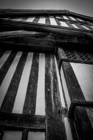 A low angle, vertical view of a striped wooden tudor house.の写真素材