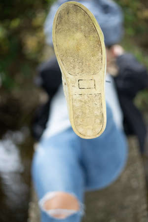 The Bottom Of A Girl's Shoe As She Kicks Her Leg Up, Portrait Orientationの写真素材