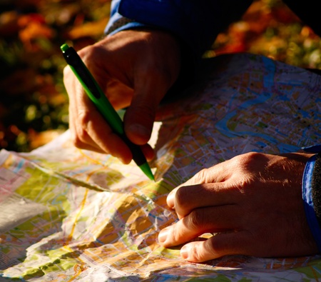 Man is planning route with pen close upの写真素材