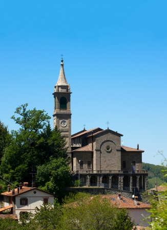 Small church with steeple in italian villageの写真素材