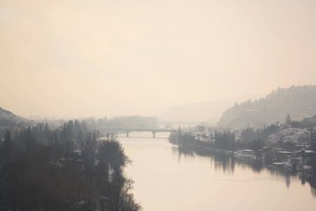 Vltava river in the morning fog. Landscape view with pink colors of sunrise. Prague, Czech.