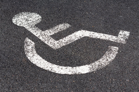 Disabled signage on road and sidewalkの写真素材
