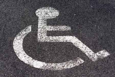 Disabled signage on road and sidewalkの写真素材