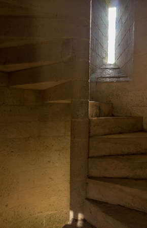 old spiral staircase made of stoneの写真素材