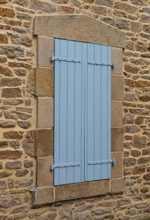 Window with blue shutters closedの写真素材