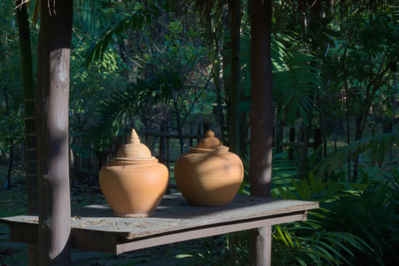 Thai clay water vessel; customary, front-of-home welcoming water source for visiting guests in Thailand.の写真素材