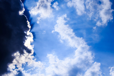 black clouds and sun rays before the rain.