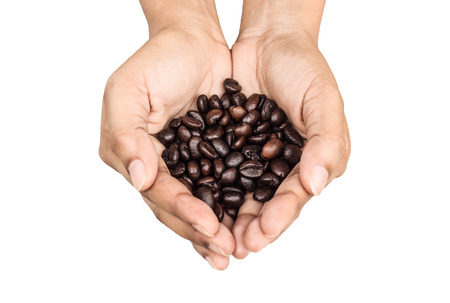 coffee beans in hand isolated on a white backgroundの写真素材