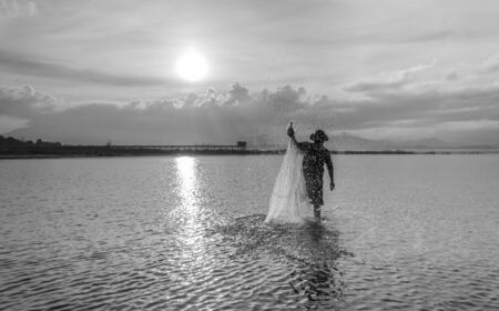 Image black and white fishermen find fish using mesh,in Thailand.の写真素材