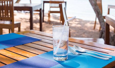 water in glass on a wooden tableの写真素材