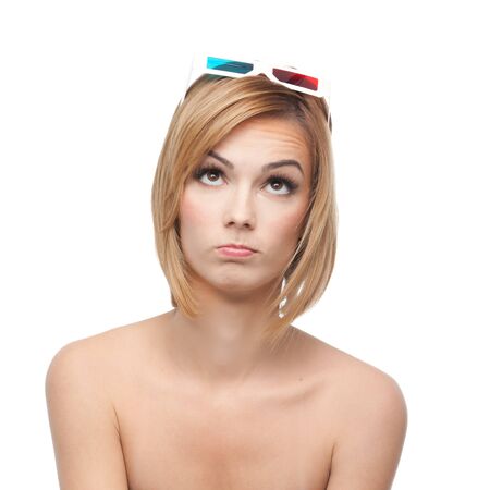 a portrait of a young, blonde woman, with a pair of 3d glasses on her head and with a funny expression on her faceの写真素材