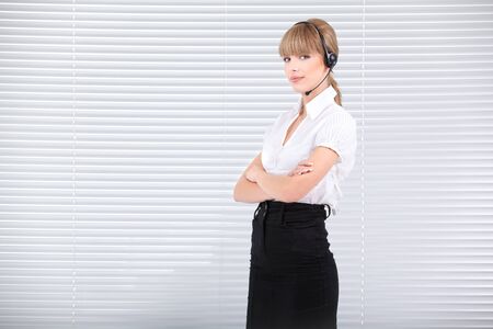 Attractive secretary with headphone on a  clean officeの写真素材