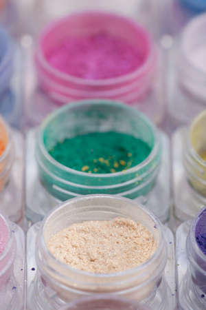a close-up image of colorful cosmetic pigments placed in small containersの写真素材