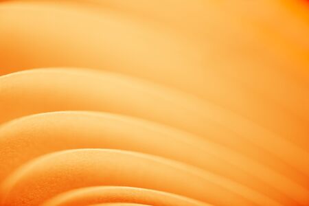 background macro image of a pattern made of curved sheets of paper in yellow  colour tones.の写真素材