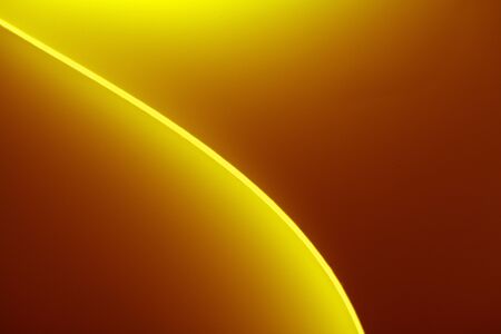 background macro image of a pattern made of curved sheets of paper in yellow and orange colour tones.の写真素材