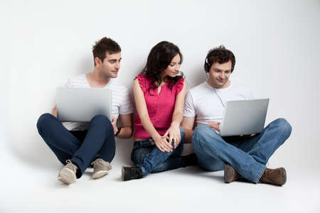 curious friends looking at laptopの写真素材