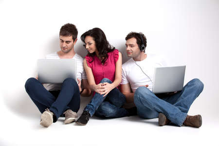 curious friends looking at laptopの写真素材