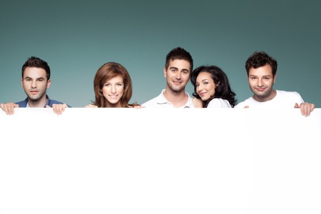 group of funny friends holding a blank bannerの写真素材