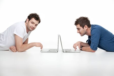 young young men looking at laptopの写真素材