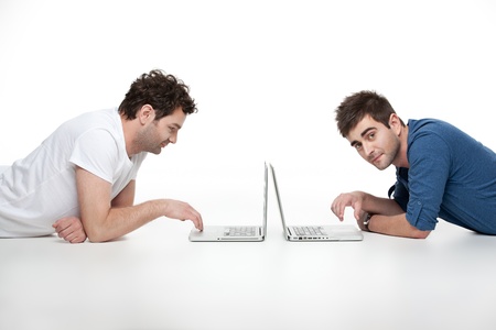 young handsome men looking at laptopの写真素材