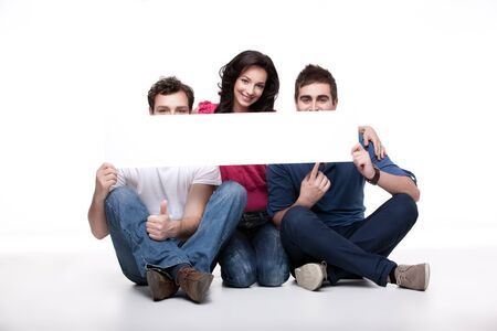 group of friends presenting blank bannerの写真素材