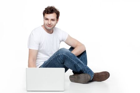casual man sitting behind laptopの写真素材