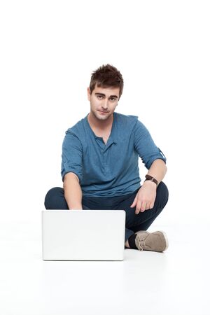 handsome man sitting with laptop looking cameraの写真素材