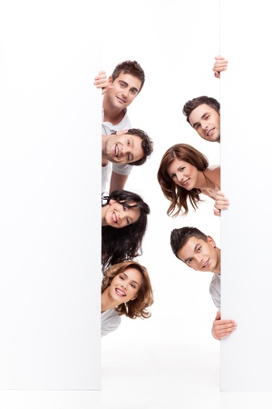 young group of people smiling behind advertising bannerの写真素材