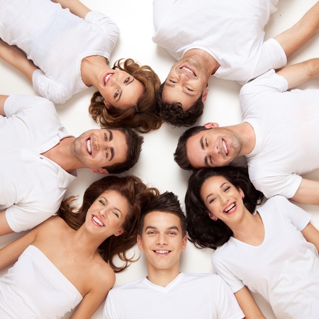 group of young people smiling in circle の写真素材