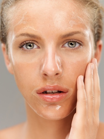 closeup portrait young woman with facial maskの写真素材