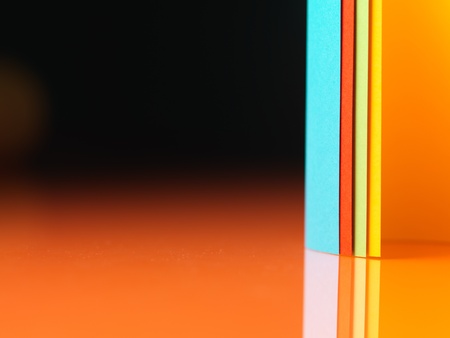 background macro image of colored origami pattern made of curved sheets of paper, with mirror...