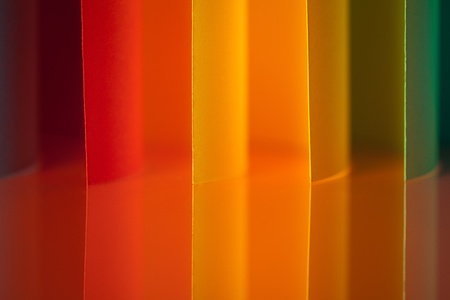 background image of colorful origami vertical pattern made of curved sheets of paper, with mirror reflexionの写真素材
