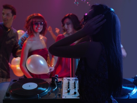 sexy, young woman dj, entertaining the crowd in a night clubの写真素材